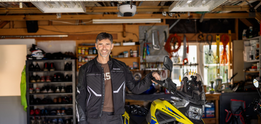 Superbike champion Andrew Stroud standing next to bike.