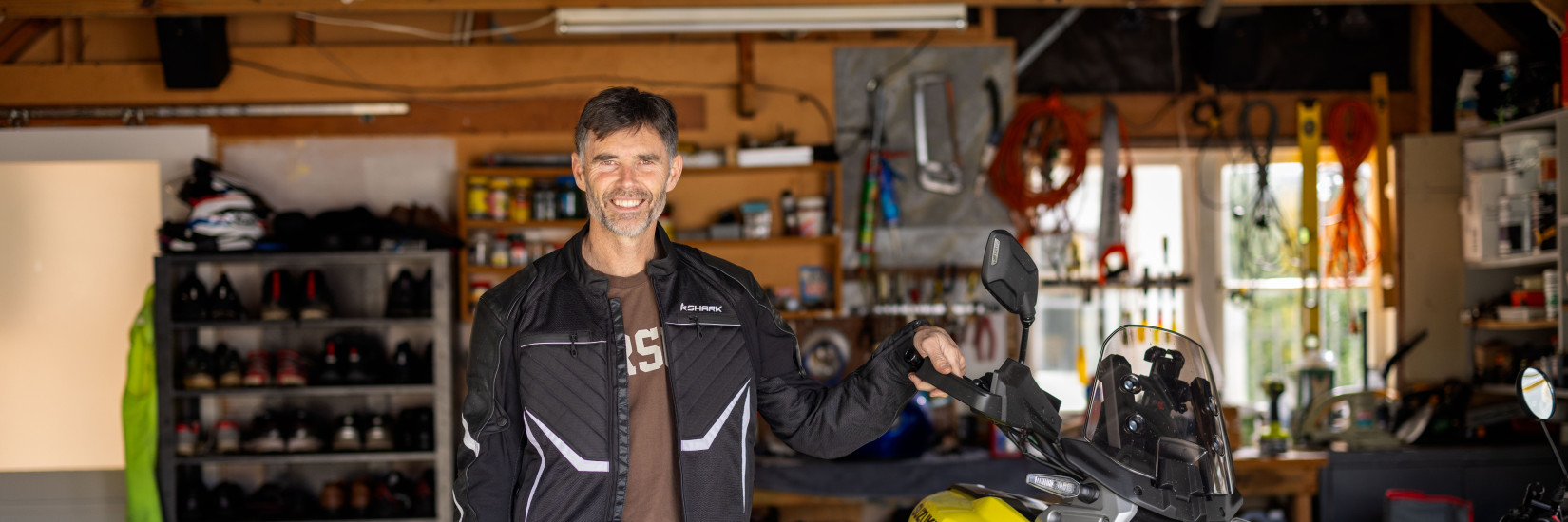 Superbike champion Andrew Stroud standing next to bike.